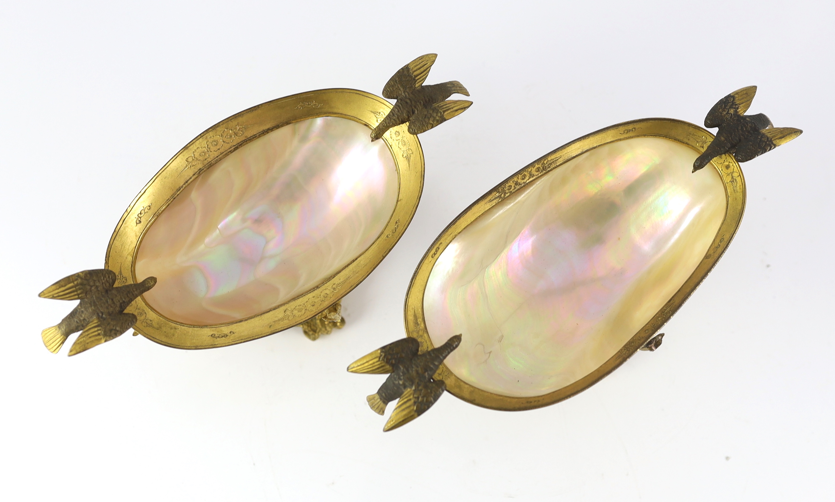 A graduated pair of 19th century Continental ormolu mounted mother of pearl pedestal bowls